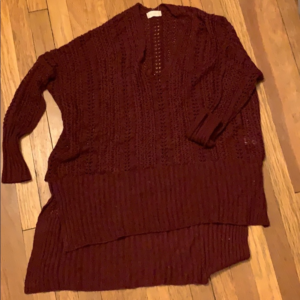 Maroon sweater. Long in back shorter in front